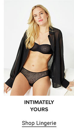 A woman in a green bra and panty set. Intimately yours. Shop designer.