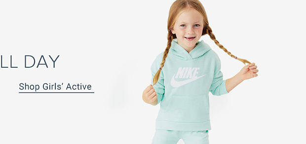 Shop girls' active. A girl in a mint-green Nike hoodie.