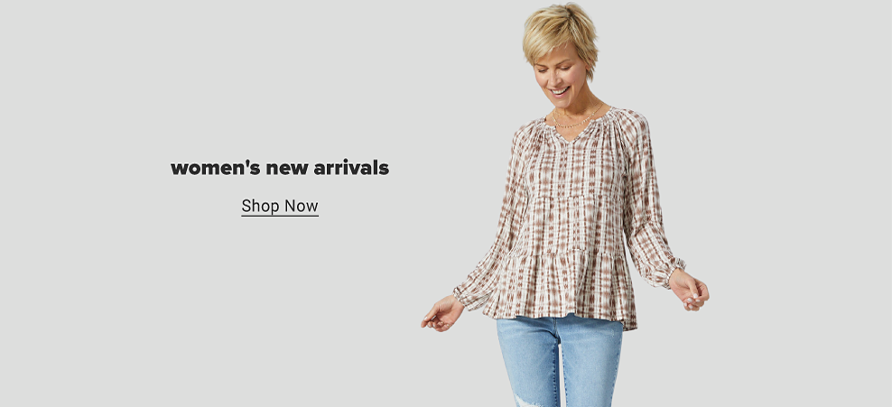 A woman in a brown and white top that's ruffled at the waist. She also wears blue jeans that are ripped above the knees. Women's new arrivals. Shop now. 