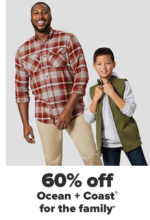 A man in a red flannel shirt and khaki pants. A little boy in a gray hoodie, an army green vest and jeans. 60% off Ocean and Coast for the family. 