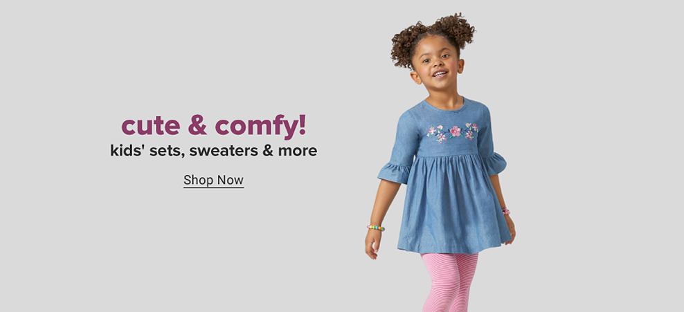 Young girl in a denim tunic with floral embroidery and pink leggings. Cute and comfy. Kids sets, sweaters and more. Shop now. 