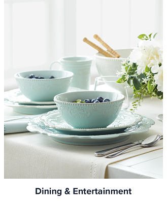 Image of bowls and plates set on a table. Shop dining and entertainment.