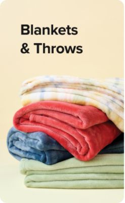 Shop comforters. A bed with blue bedding.