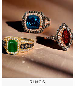 Gemstone diamond rings in green, blue and red. Shop rings.