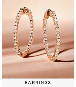 A pair of diamond hoop earrings. Shop earrings.