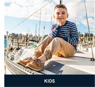 Image of a boy wearing Sperry shoes. Shop kids.