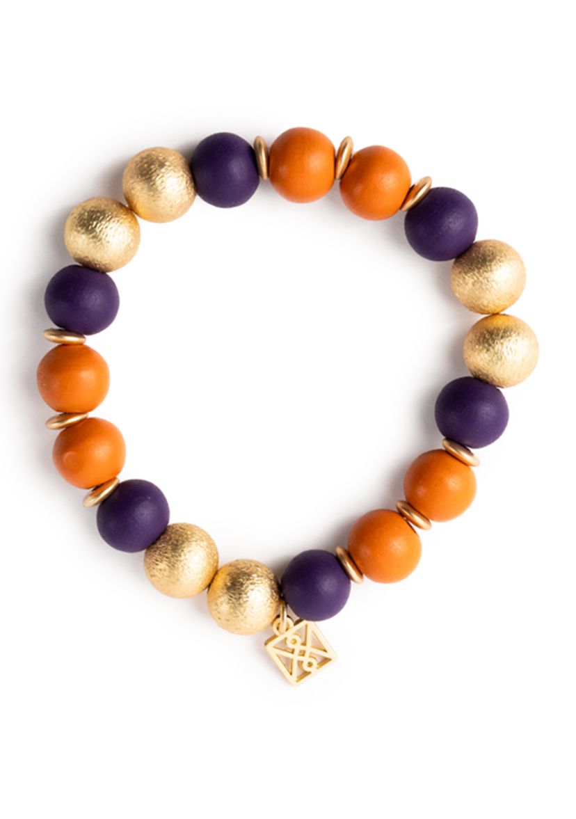 Rep your team in style with the Nori beaded bracelet from Mary Square, featuring a mix of colorful and gold beads with a logo charm.