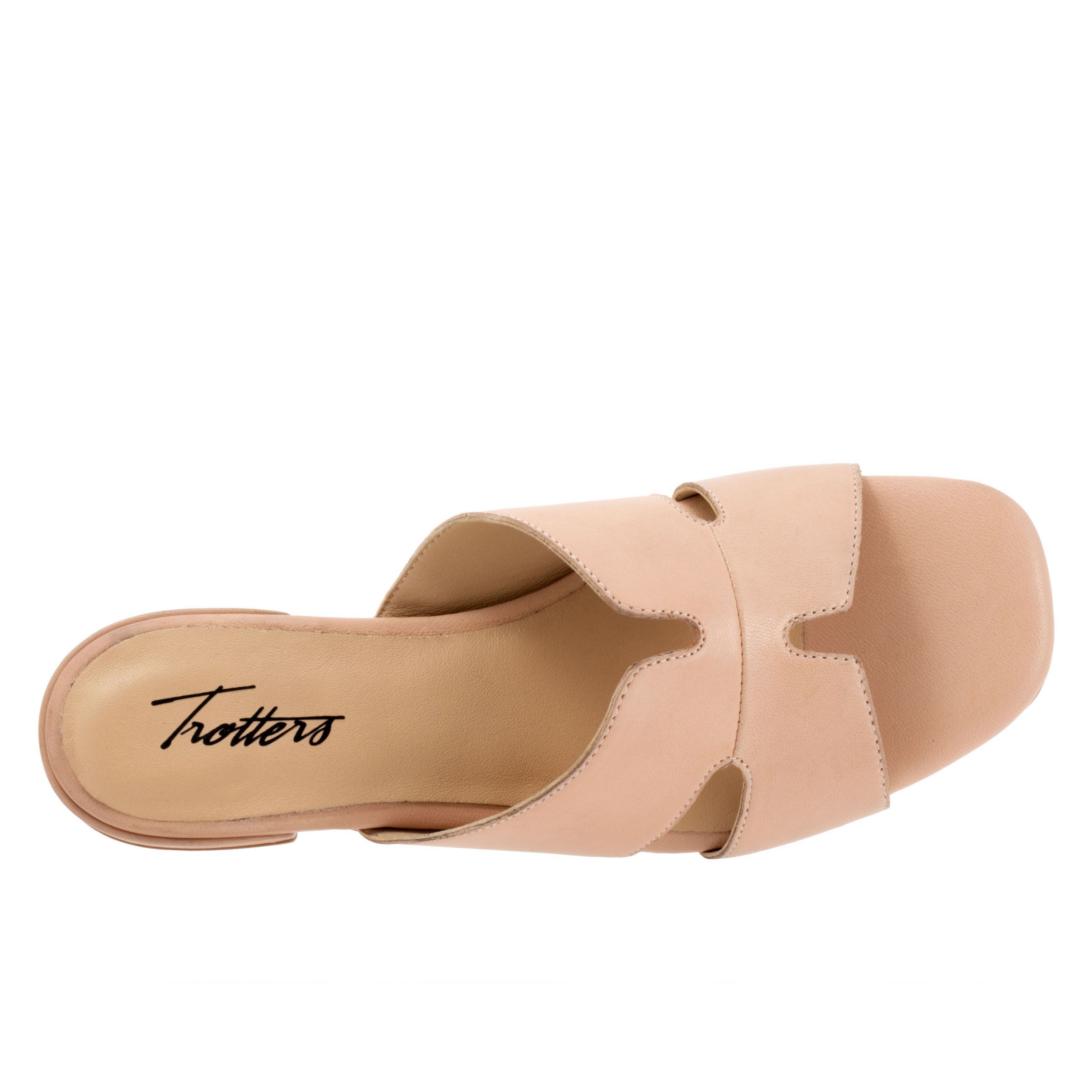Cut outs give the Nell sandal a unique and fun style youll love. With a leather upper and soft leather lining, youll love the luxurious feel of the Nell sandal.