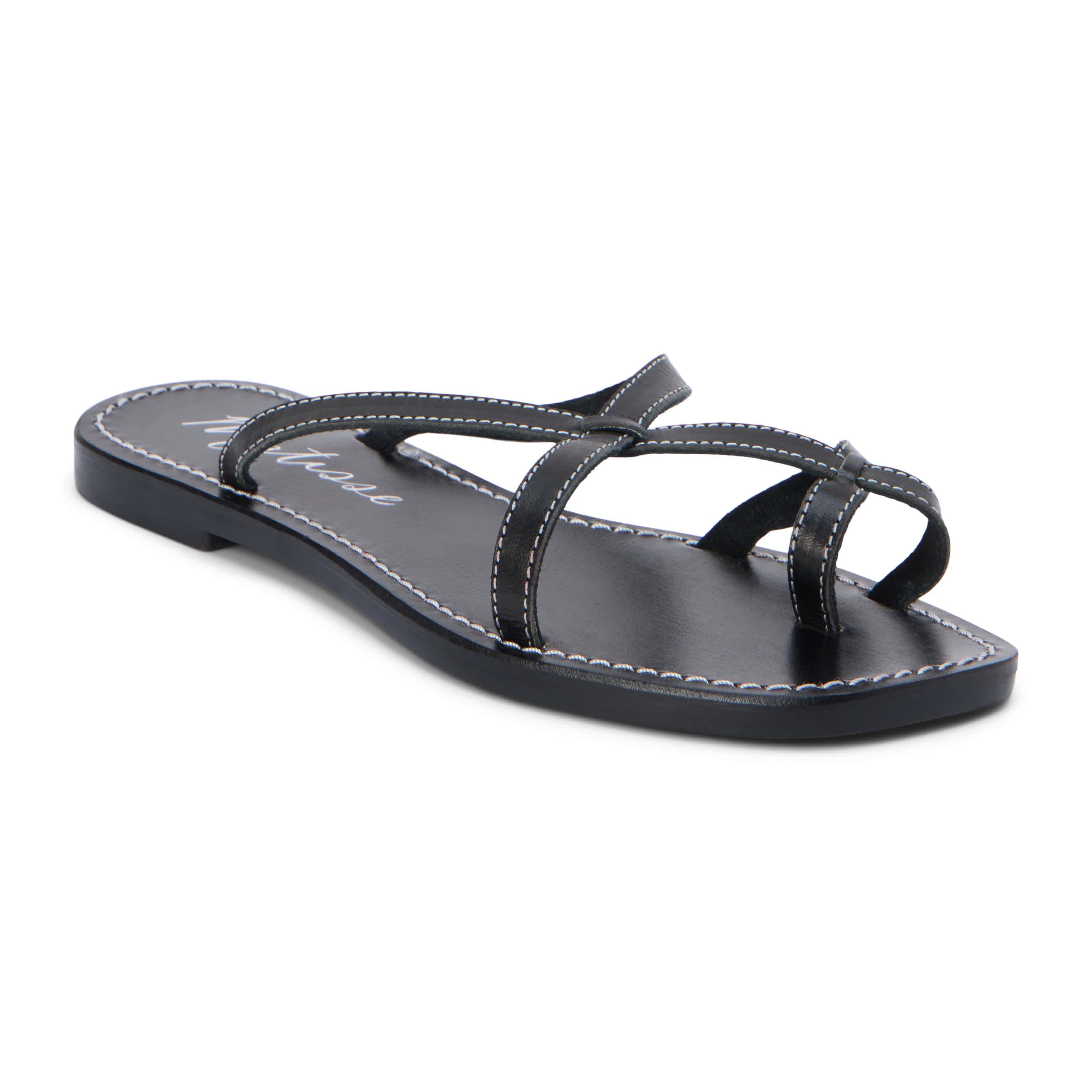 Flat sandal with criss-cross straps and toe thong.