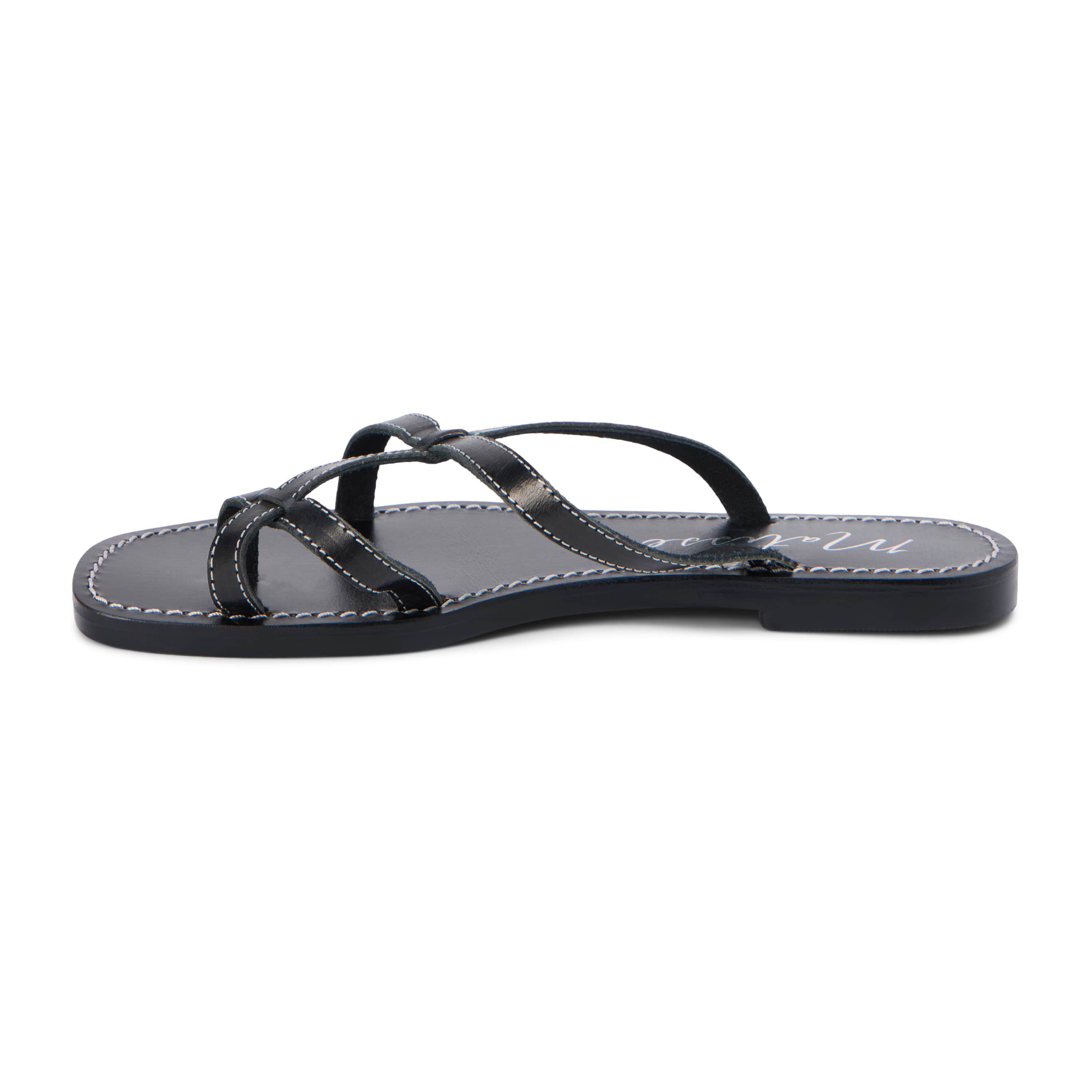 Flat sandal with criss-cross straps and toe thong.