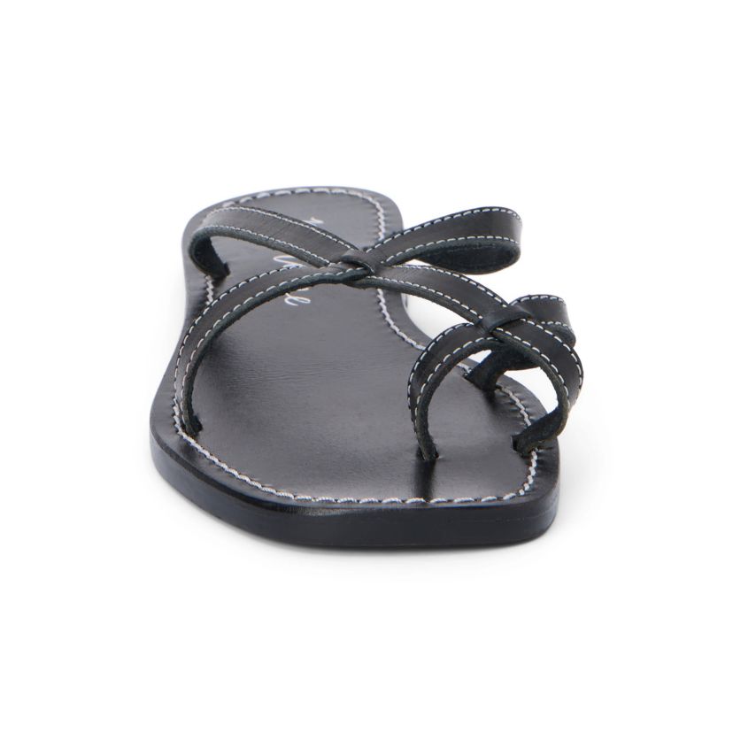 Flat sandal with criss-cross straps and toe thong.