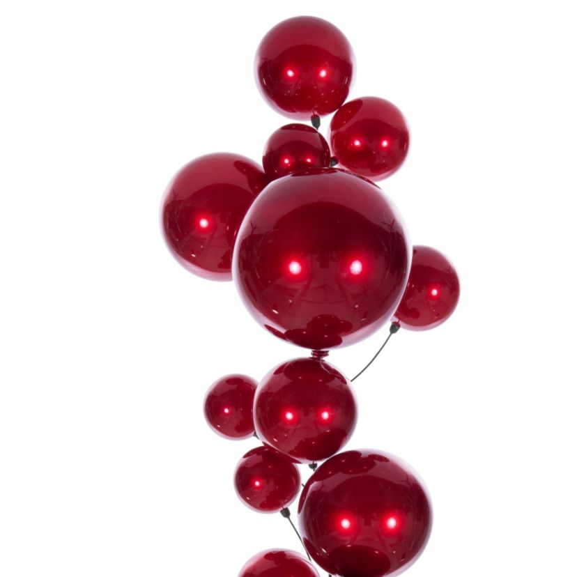 Vickerman 6 Red Ball Branch Garland. It has: eight 3-inch ornaments, eight 4-inch ornaments, four 4.75-inch, four 6-inch, and four 8-inch ornaments, for a total of twenty-eight ornaments on the garland. It features ornaments in candy finish. Green spine with a loop hanger.