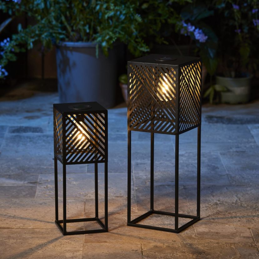 23.75"H / 17.75"H Set of 2 Black Metal Stripes Geometric Solar Powered Edison Bulb Outdoor Floor Lantern or planter standsL: 8"L X 8"W X 23.75"HS: 6.5"L X 6.5"W X 17.75"H