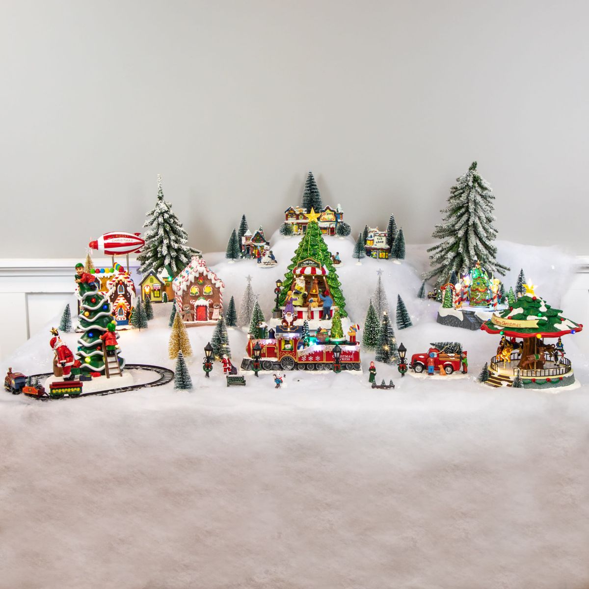 7-Piece Christmas Village Figurine and Tree Display Set