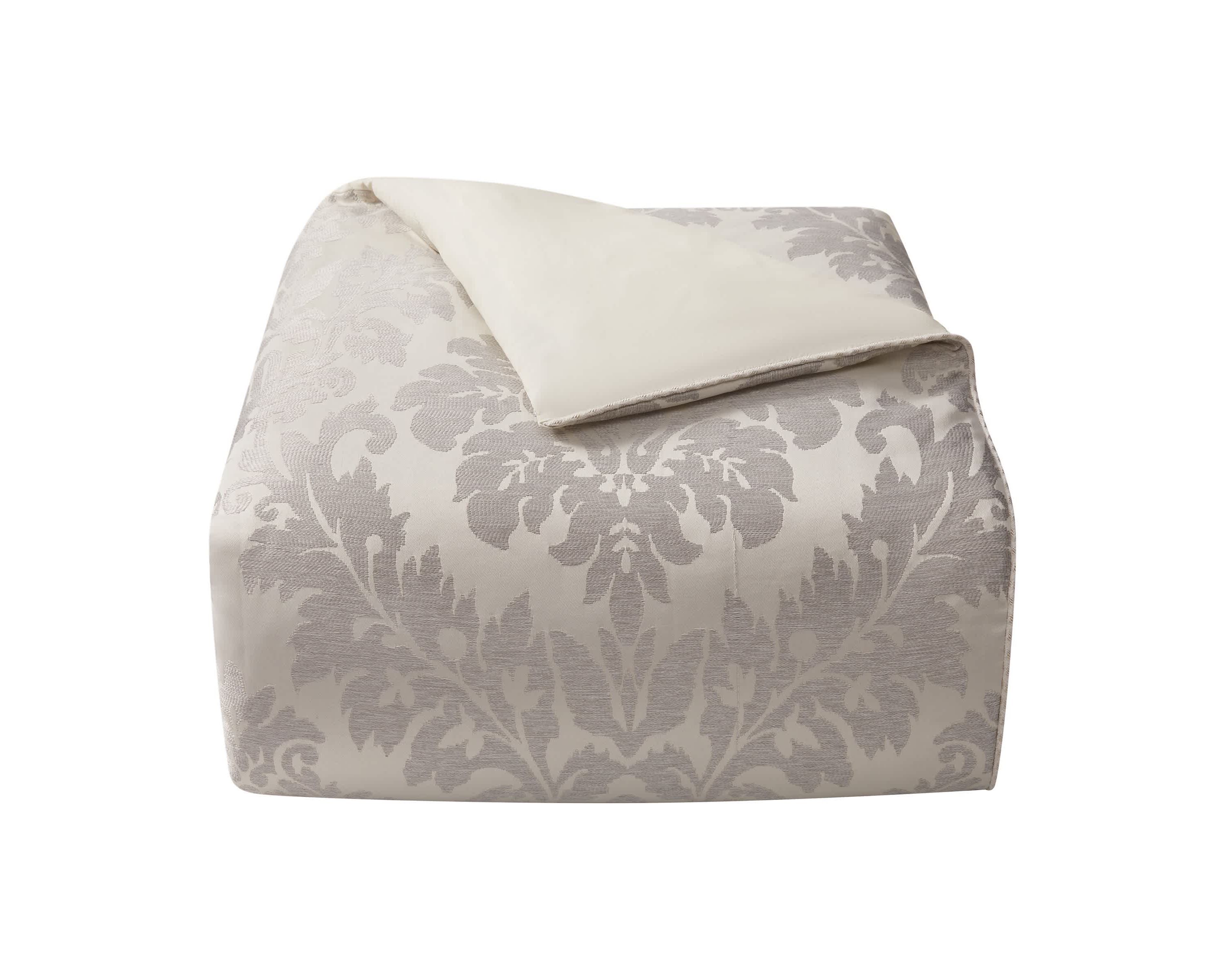 The large scale woven damask with an hourglass design provides a stunning update to your bedroom. The ivory and platinum four piece set includes a comforter with matching pillow shams and center pleat bedskirt.