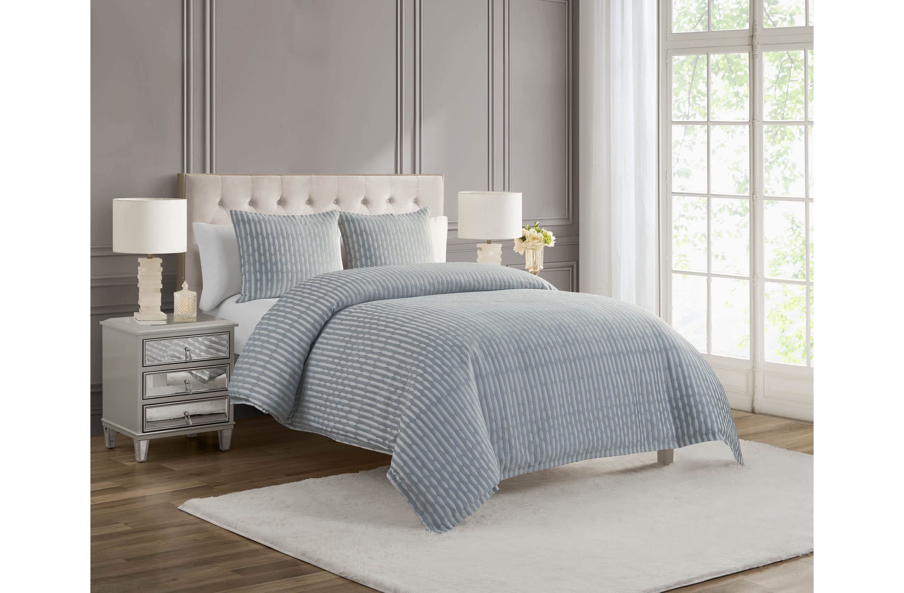 The Waterford Aretha Blue 3-Piece Comforter Set is the epitome of refined luxury, designed to bring a sense of serenity and sophistication to your bedroom. This elegant set includes a beautifully crafted comforter and two coordinating shams, all featuring a rich, soothing blue tone that complements a wide range of bedroom styles. The comforter’s intricate pattern, subtle  texture and depth, creates a timeless, opulent look that is both classic and contemporary. Expertly constructed from high-quality fabrics, this comforter set offers a soft, luxurious feel while providing exceptional warmth and comfort for a restful night’s sleep. The Waterford Aretha Blue Comforter Set is perfect for those seeking to add a touch of elegance to their master bedroom, guest room, or even a chic hotel-inspired retreat. Durable and easy to care for, this set is not only a stunning visual addition to your space but also a practical one. With its combination of craftsmanship, style, and comfort, the Waterford Aretha Blue 3-Piece Comforter Set offers lasting beauty and luxury for your home. Elevate your bedroom decor today with this exquisite set and indulge in the ultimate in sophisticated bedding.