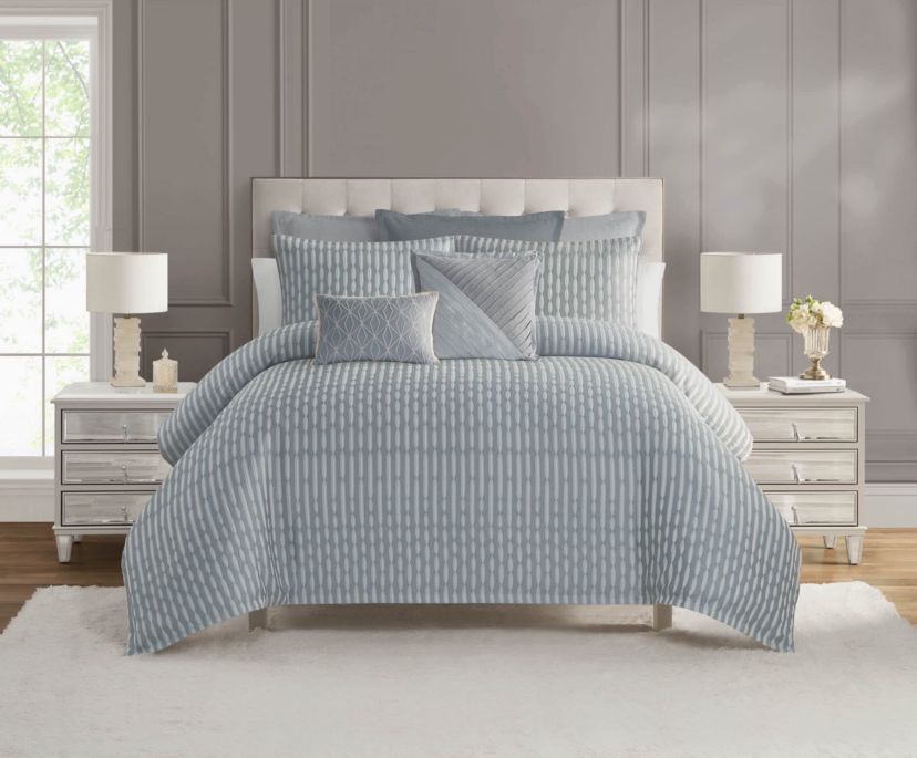 The Waterford Aretha Blue 3-Piece Comforter Set is the epitome of refined luxury, designed to bring a sense of serenity and sophistication to your bedroom. This elegant set includes a beautifully crafted comforter and two coordinating shams, all featuring a rich, soothing blue tone that complements a wide range of bedroom styles. The comforter’s intricate pattern, subtle  texture and depth, creates a timeless, opulent look that is both classic and contemporary. Expertly constructed from high-quality fabrics, this comforter set offers a soft, luxurious feel while providing exceptional warmth and comfort for a restful night’s sleep. The Waterford Aretha Blue Comforter Set is perfect for those seeking to add a touch of elegance to their master bedroom, guest room, or even a chic hotel-inspired retreat. Durable and easy to care for, this set is not only a stunning visual addition to your space but also a practical one. With its combination of craftsmanship, style, and comfort, the Waterford Aretha Blue 3-Piece Comforter Set offers lasting beauty and luxury for your home. Elevate your bedroom decor today with this exquisite set and indulge in the ultimate in sophisticated bedding.