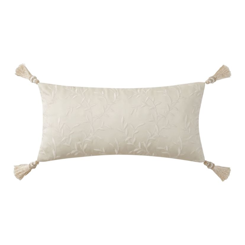 The ivory Arderra 11" x 22" exquisite decorative pillow features an embroidered leaf design. The pillow reverses to a herringbone pattern and is finished with four corner tassels.