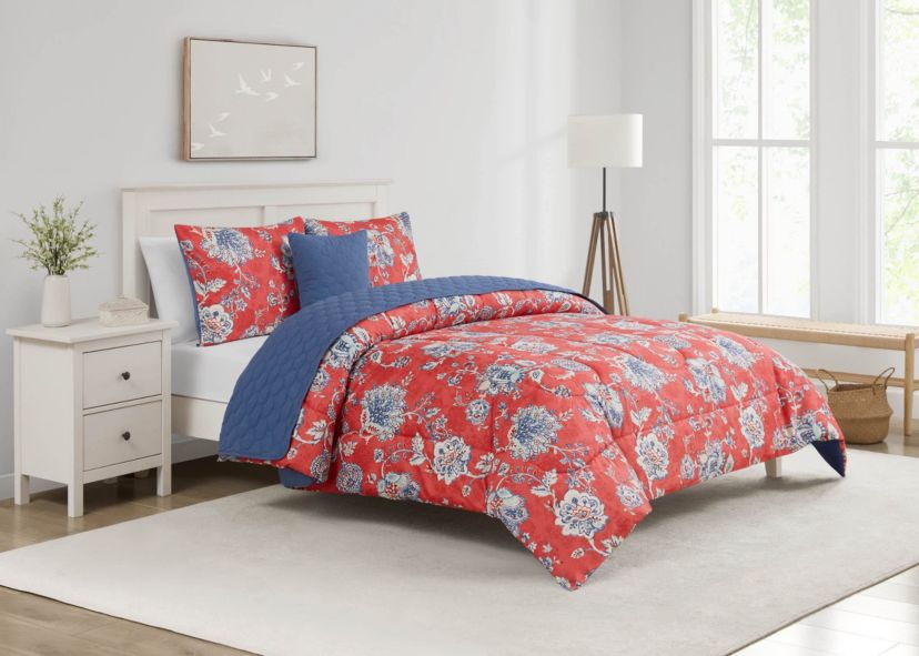 Brighten your bedroom with the Zinnia Blue 5pc Comforter and Quilt Set. Featuring a vibrant red floral print with a reversible blue quilt, this set includes a comforter, quilt, 2 shams, and a decorative pillow—perfect for bold style and cozy, layered comfort year-round.