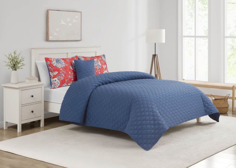 Brighten your bedroom with the Zinnia Blue 5pc Comforter and Quilt Set. Featuring a vibrant red floral print with a reversible blue quilt, this set includes a comforter, quilt, 2 shams, and a decorative pillow—perfect for bold style and cozy, layered comfort year-round.
