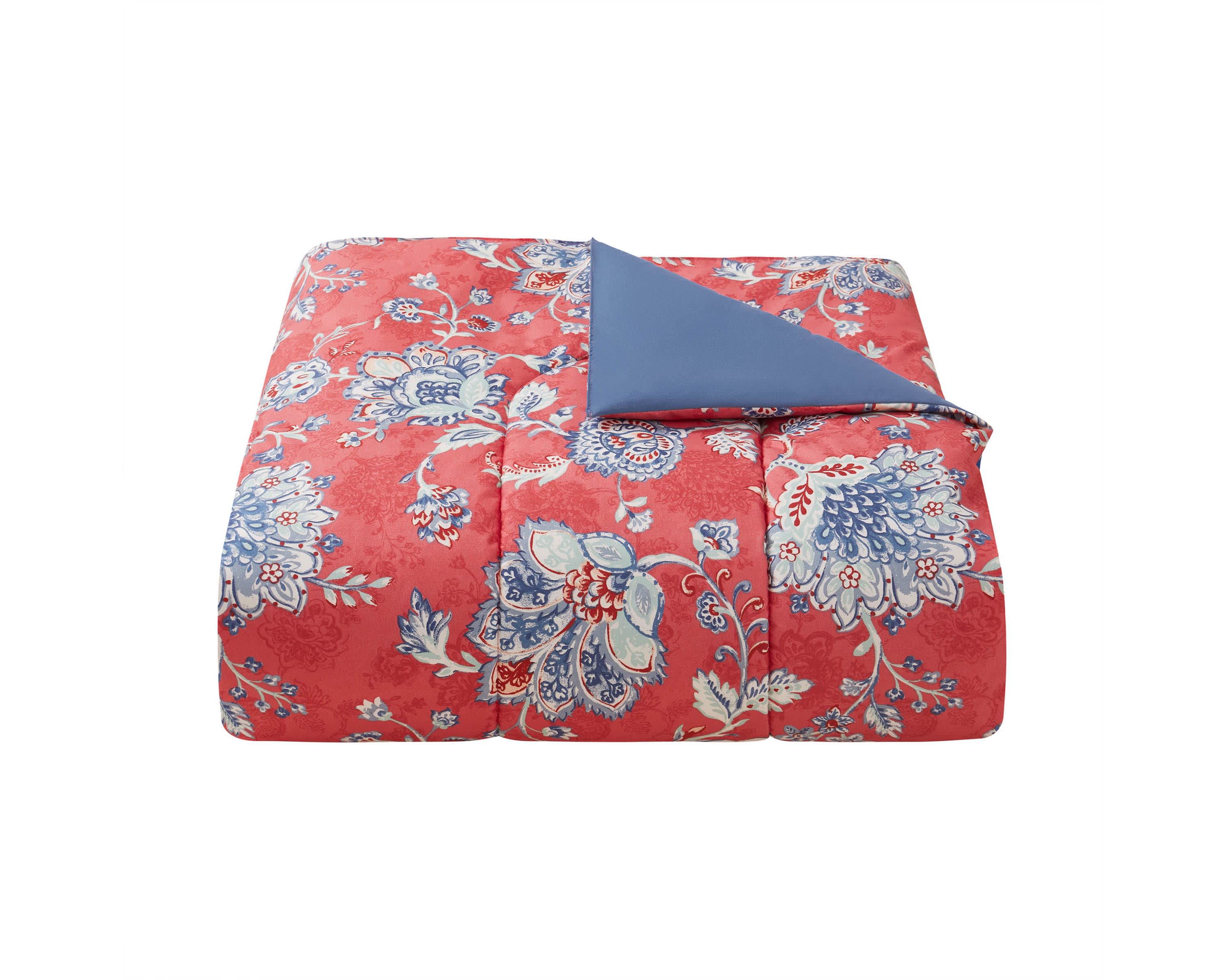 Brighten your bedroom with the Zinnia Blue 5pc Comforter and Quilt Set. Featuring a vibrant red floral print with a reversible blue quilt, this set includes a comforter, quilt, 2 shams, and a decorative pillow—perfect for bold style and cozy, layered comfort year-round.